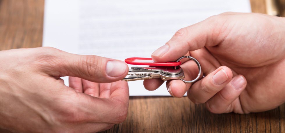 Real Estate Agent Giving House Key To Owner