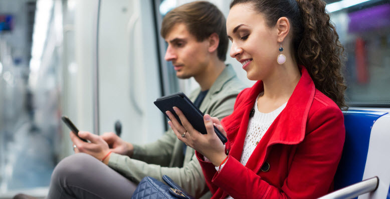 Couple reading text message in train