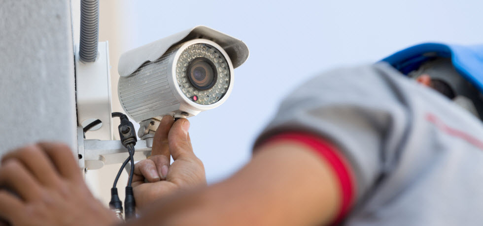 Technician installing CCTV camera