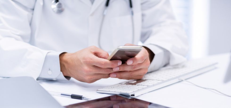 A doctor reading text message