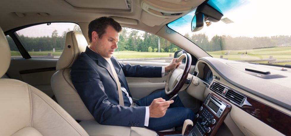 Businessman texting and driving