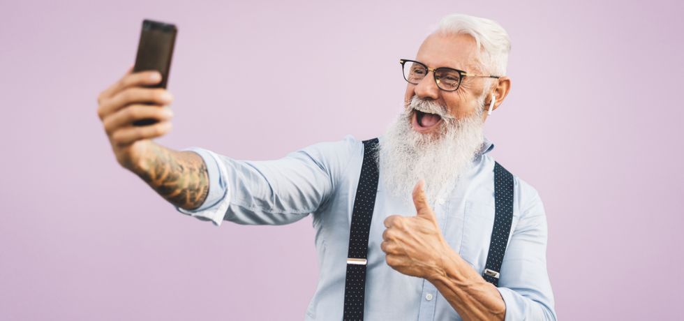 Senior happy man making selfie with smartphone