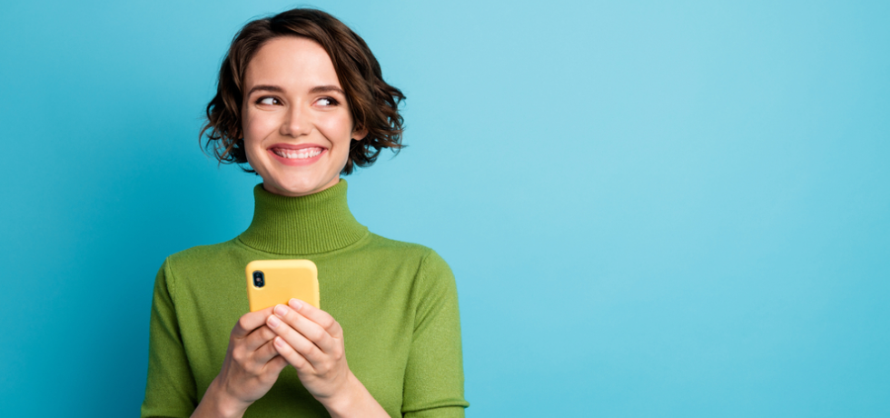 Excited woman with a mobile phone in hand