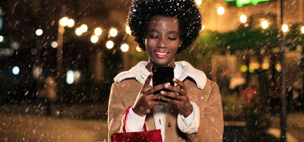 Young afro American woman reading a happy new year text message
