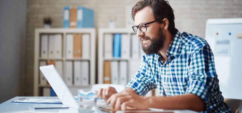 A businessman typing email to text message