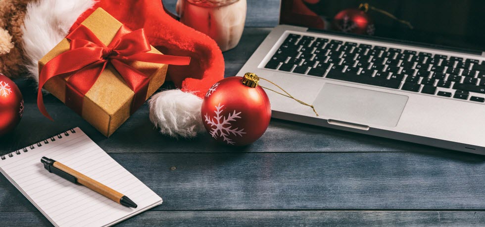 working desk with laptop and Christmas presents