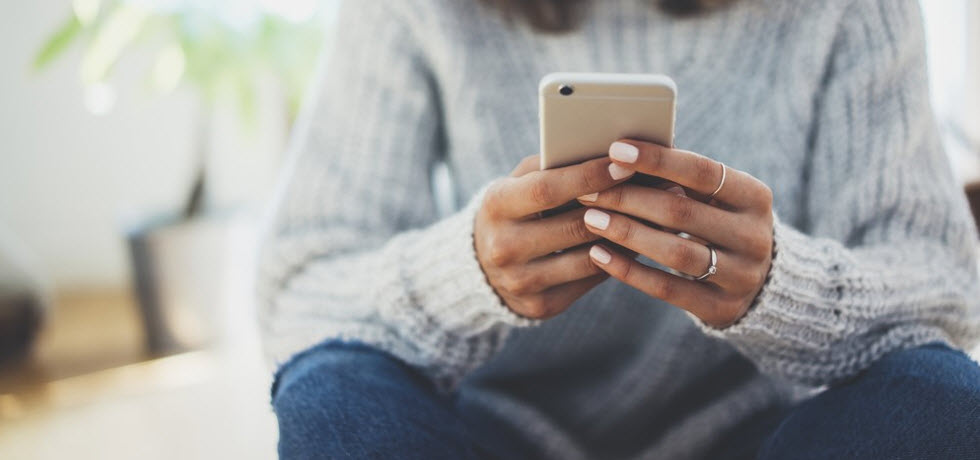 A woman reading a text message